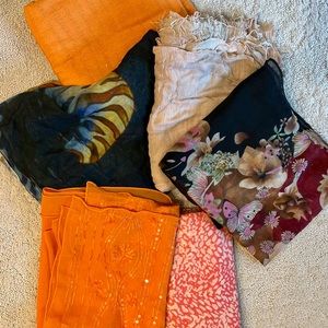 Assortment of six wraps and scarves purchase values between $14.99 and 54.99.